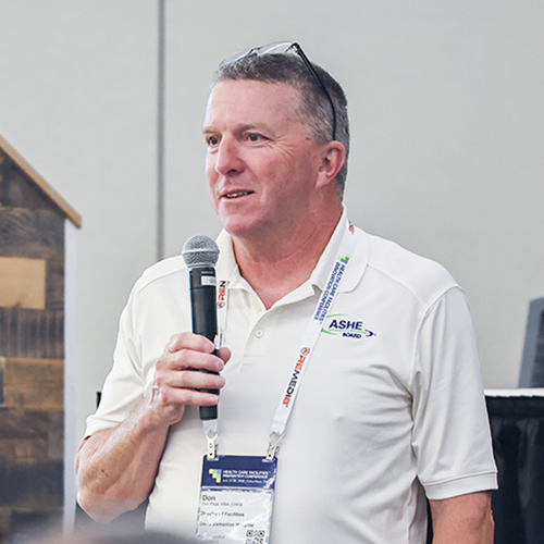 man standing holding microphone