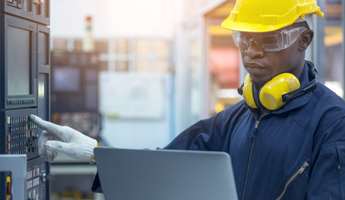 man with hard hat and headphones adjusting system