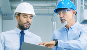 two men in hard hats with business attire